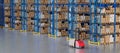 Warehouse Scene with High Shelves and Reach Fork Track