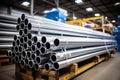 A warehouse stack of shiny new industrial metal tubes for construction and engineering