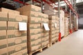 Warehouse with stacks of boxes on wooden pallets. Wholesaling