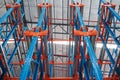 Warehouse storage interior with colorful steel shelves, pallet r