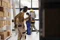 Warehouse supervisor holding clipboard and dancing in stockroom Royalty Free Stock Photo