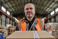 Warehouse worker carrying boxes in storehouse Royalty Free Stock Photo