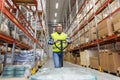 Warehouse worker carrying loader with goods Royalty Free Stock Photo
