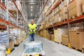 Warehouse worker carrying loader with goods Royalty Free Stock Photo