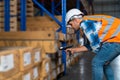 Warehouse worker checking the packages using barcode reader in a large warehouse distribution center Royalty Free Stock Photo