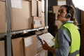 A warehouse worker checks the items against an inventory list on a clipboard. A logistics manager takes inventory using Royalty Free Stock Photo