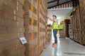 Warehouse worker courier inspecting checklist stock cardboard boxes for sale with warehouse workers characters unloading boxes