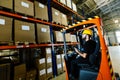 Warehouse worker doing logistics work with forklift loader Royalty Free Stock Photo