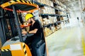 Warehouse worker doing logistics work with forklift loader