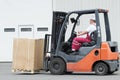 Warehouse worker driver in forklift Royalty Free Stock Photo