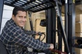 Warehouse Worker Driving Forklift Royalty Free Stock Photo