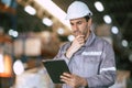 Warehouse worker, Engineer manager looking at tablet screen with thinking have a problem expression Royalty Free Stock Photo