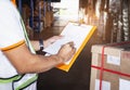 Warehouse worker holding clipboard his doing inventory management cargo boxes. Checking stock, Cargo shipment, Warehousing storage Royalty Free Stock Photo