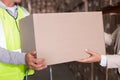 Warehouse worker and manager passing a box Royalty Free Stock Photo