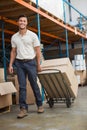 Warehouse worker moving boxes on trolley Royalty Free Stock Photo