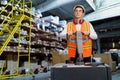 Warehouse worker operates a pallet loader.