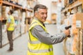 Warehouse worker scanning barcode on box