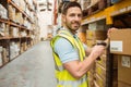 Warehouse worker scanning box while smiling at camera Royalty Free Stock Photo