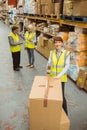 Warehouse worker sealing cardboard boxes for shipping Royalty Free Stock Photo