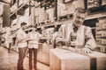 Warehouse worker sealing cardboard boxes for shipping Royalty Free Stock Photo