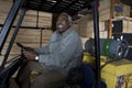 Warehouse Worker Sitting In Forklift Royalty Free Stock Photo