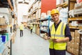 Warehouse worker smiling at camera with clipboard Royalty Free Stock Photo