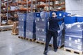 Warehouse worker stacking boxes on pallets in distribution center Royalty Free Stock Photo