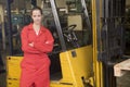 Warehouse worker standing by forklift Royalty Free Stock Photo
