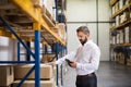 Warehouse worker or supervisor with barcode scanner.