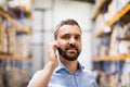 Warehouse worker or supervisor with a smartphone. Royalty Free Stock Photo