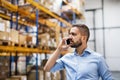 Warehouse worker or supervisor with a smartphone. Royalty Free Stock Photo