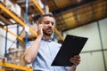 Warehouse worker or supervisor with a smartphone. Royalty Free Stock Photo