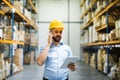 Warehouse worker or supervisor with a smartphone. Royalty Free Stock Photo