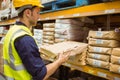Warehouse worker taking package in the shelf Royalty Free Stock Photo