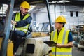 warehouse worker talking with forklift operator in factory Royalty Free Stock Photo