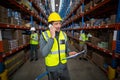 Warehouse worker talking on mobile phone and holding clipboard Royalty Free Stock Photo