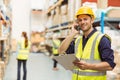 Warehouse worker talking on the phone holding clipboard Royalty Free Stock Photo