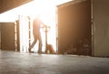 Warehouse Worker Unloading Package Boxes Out of The Inside Cargo Container. Truck Parked Loading at Dock Warehouse. Royalty Free Stock Photo