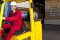 Warehouse worker using forklift truck Royalty Free Stock Photo