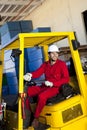Warehouse worker using forklift truck Royalty Free Stock Photo