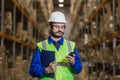 Warehouse worker using mobile phone Royalty Free Stock Photo