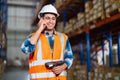 Warehouse worker using a phone holding barcode reader working in a distribution center Royalty Free Stock Photo