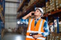 Warehouse worker using a phone holding barcode reader working in a distribution center Royalty Free Stock Photo