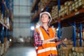 Warehouse worker working process checking the package using laptop in large warehouse distribution center Royalty Free Stock Photo