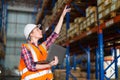 Warehouse worker working process checking the package using laptop in large warehouse distribution center. Caucasian female Royalty Free Stock Photo