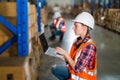 Warehouse worker working process checking the package using laptop in large warehouse distribution center Royalty Free Stock Photo