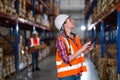 Warehouse worker working process checking the package using a tablet in a large warehouse distribution center Royalty Free Stock Photo