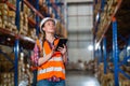 Warehouse worker working process checking the package using a tablet in a large warehouse distribution center Royalty Free Stock Photo