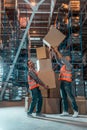 full length view of two workers in vests holding boxes Royalty Free Stock Photo