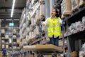 Warehouse workers Check stock details in storage area putting them on shelves. work in distribution center Royalty Free Stock Photo